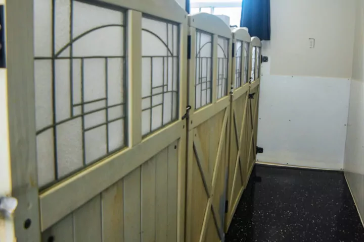 Wooden partition with decorative glass panels indoors.